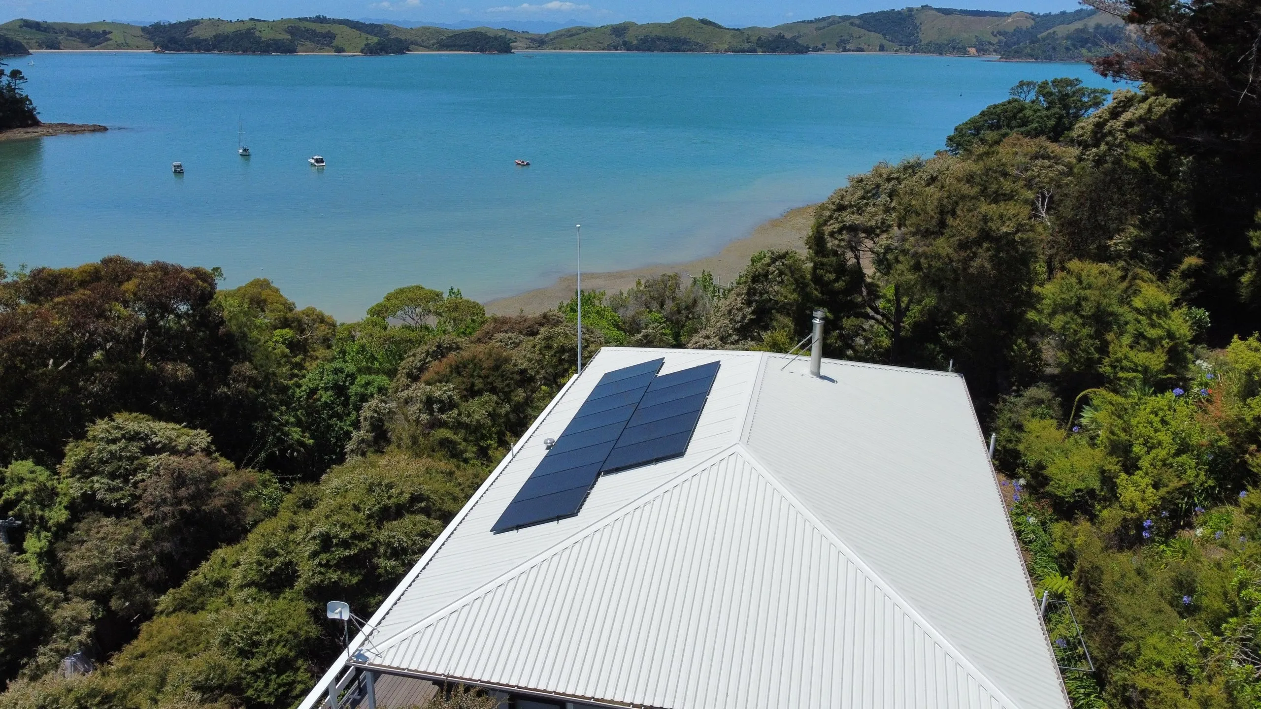 Drone view of a Vital Energy solar array on a coastal Auckland home