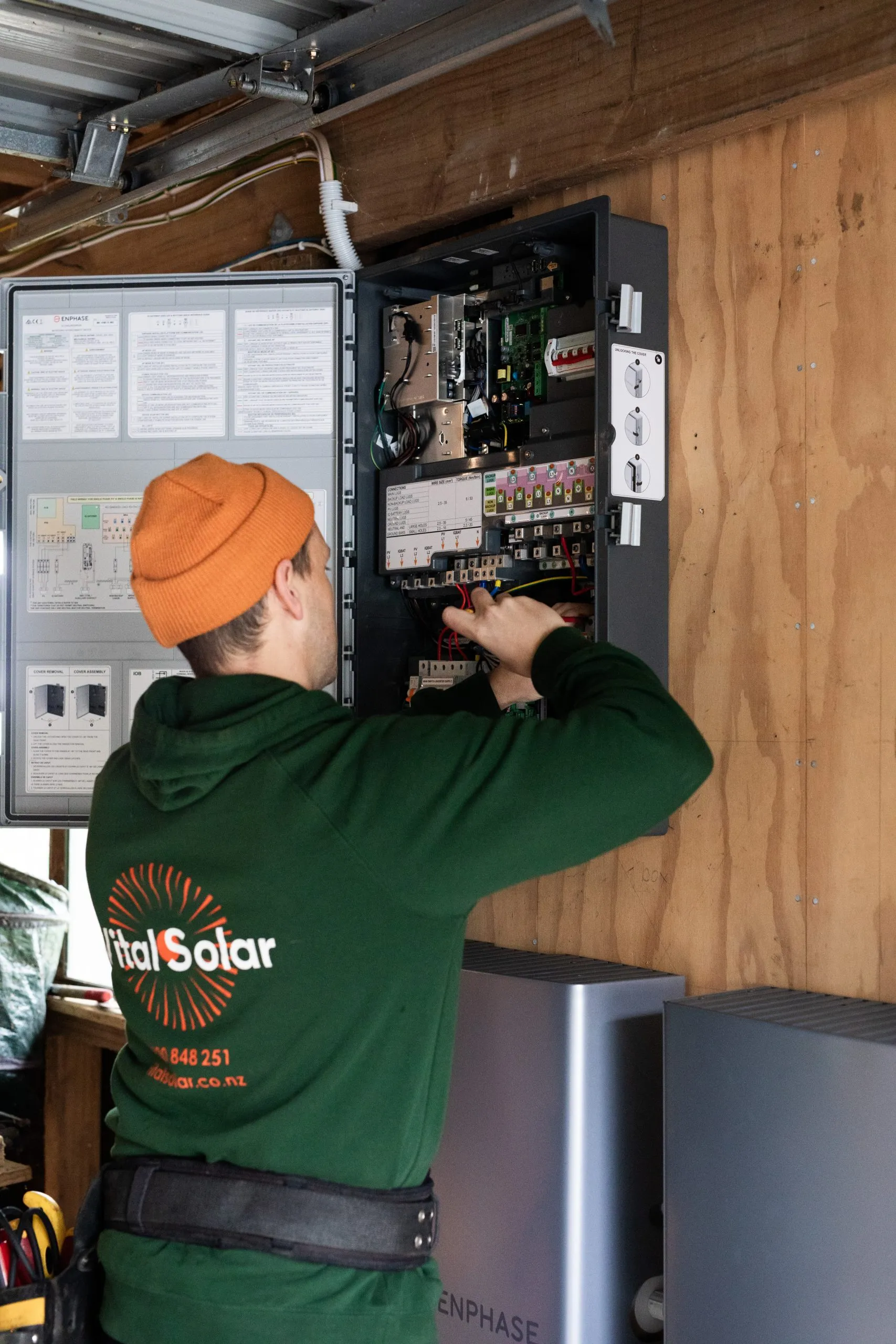 Vital Energy electrician wiring a switchboard