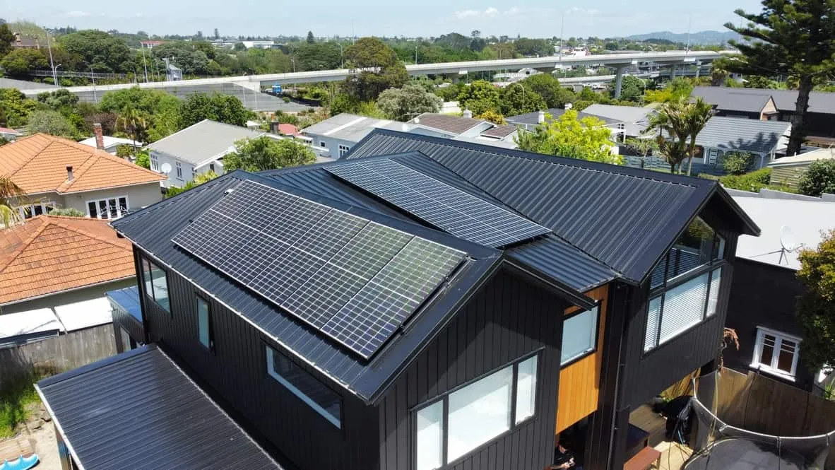 All-black solar panels on the roof of a black weatherboard home in Point Chevalier
