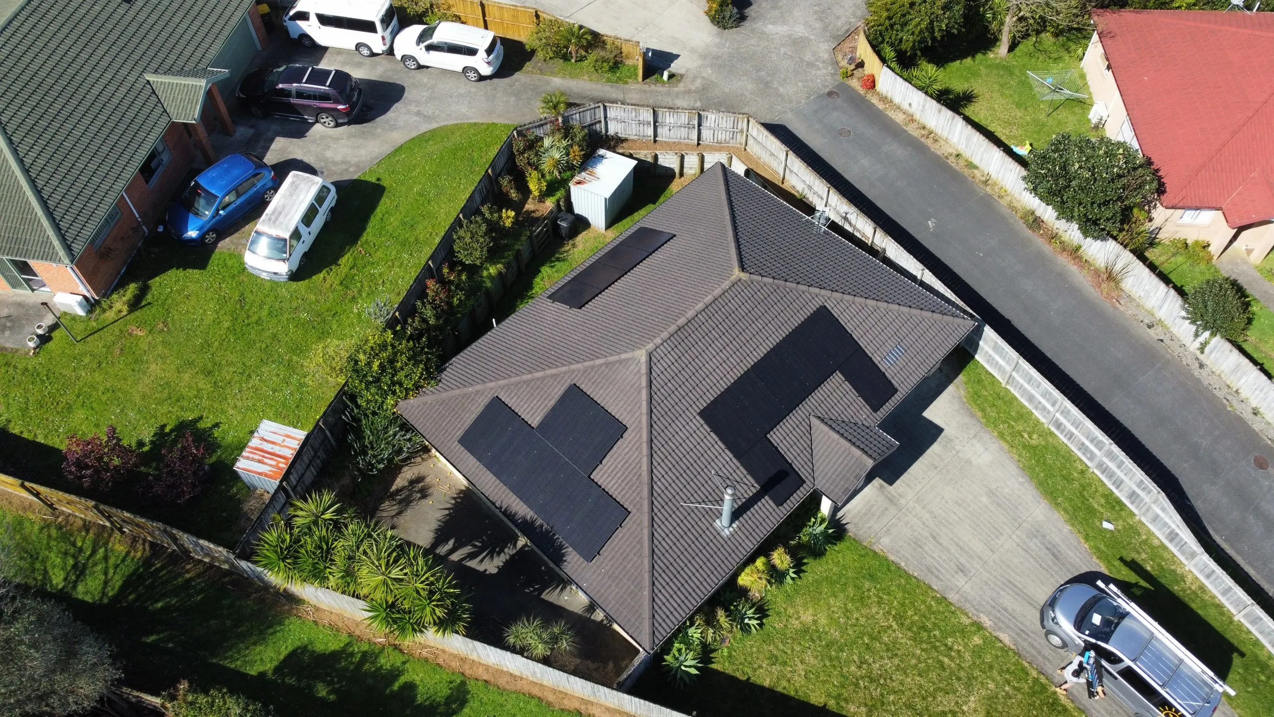 Drone view of a solar array on a tiled roof in suburban West Auckland